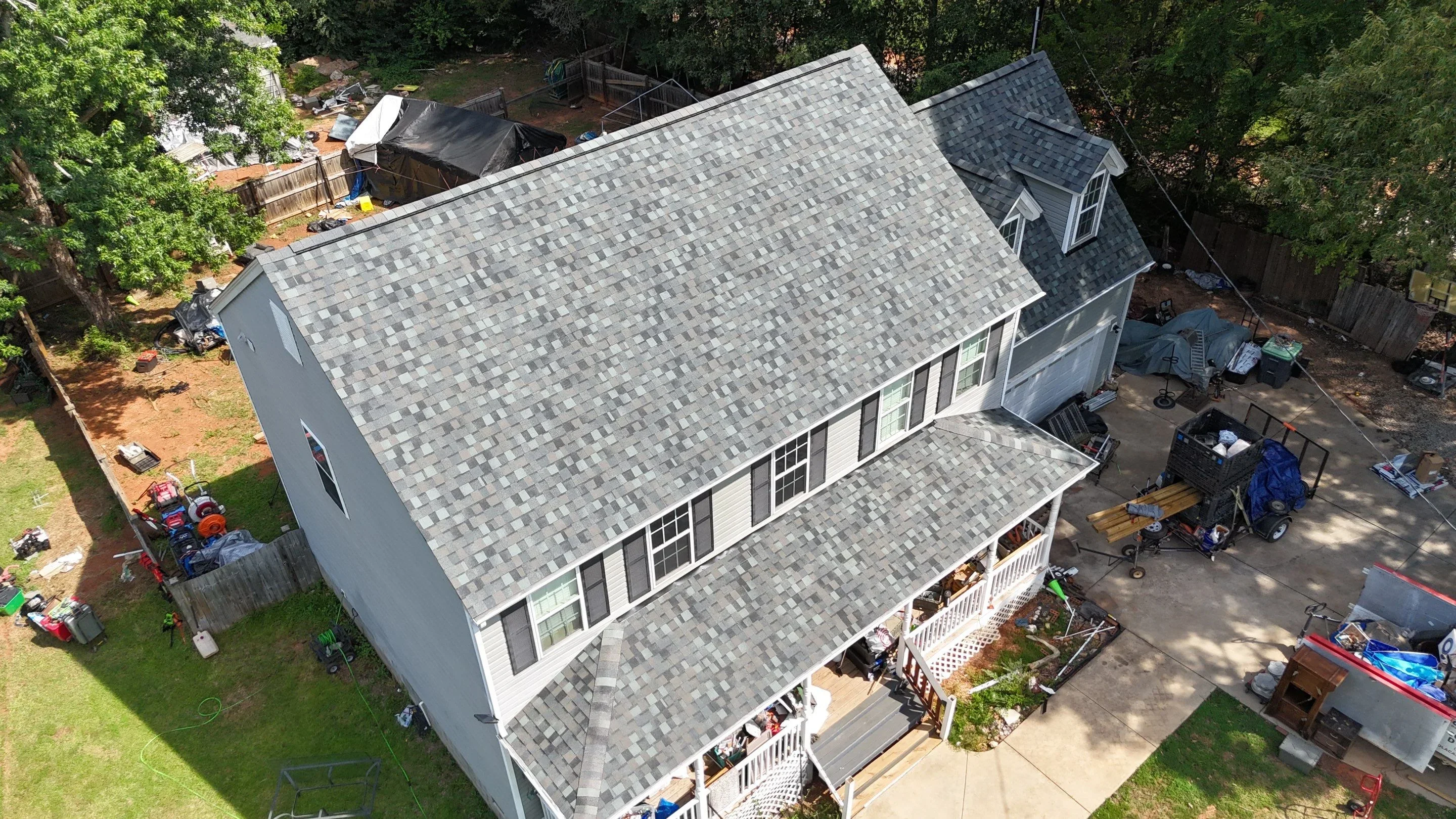 New architectural shingle roof with gray multi-tonal shingles on two-story residential home