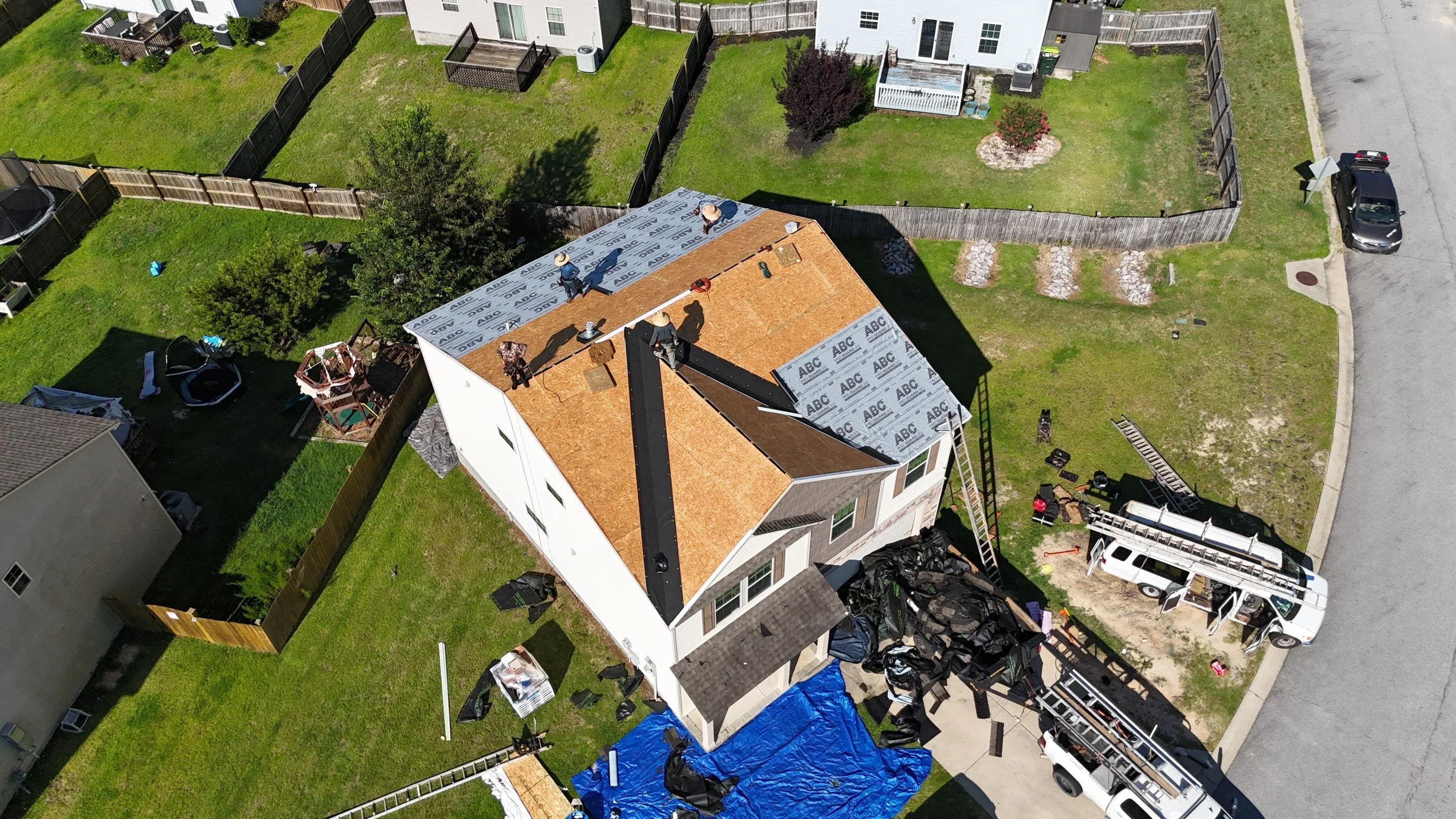 Residential roof replacement with cork underlayment and ice and water shield visible during installation