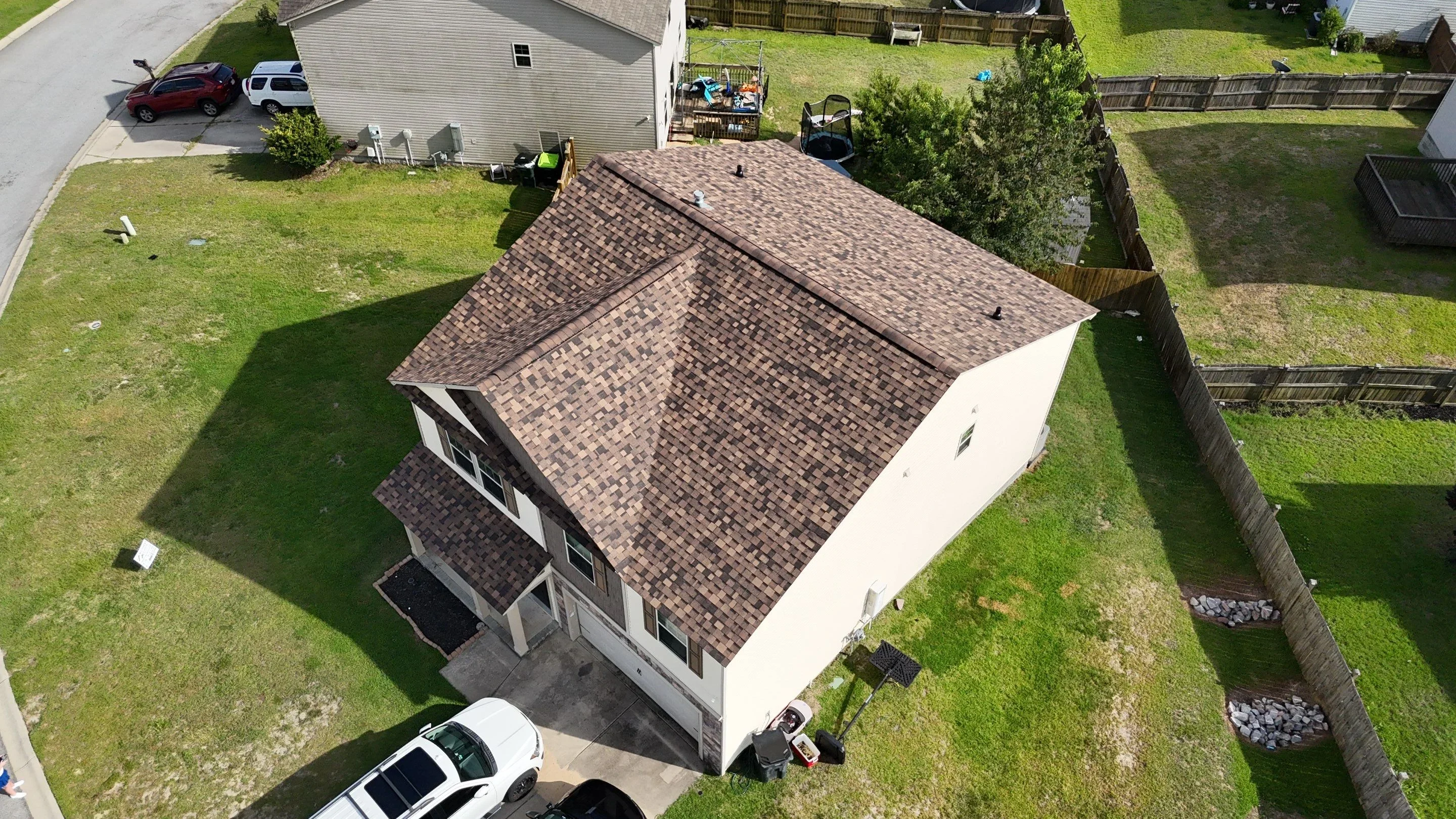 New architectural shingle roof with brown dimensional shingles on residential home addition