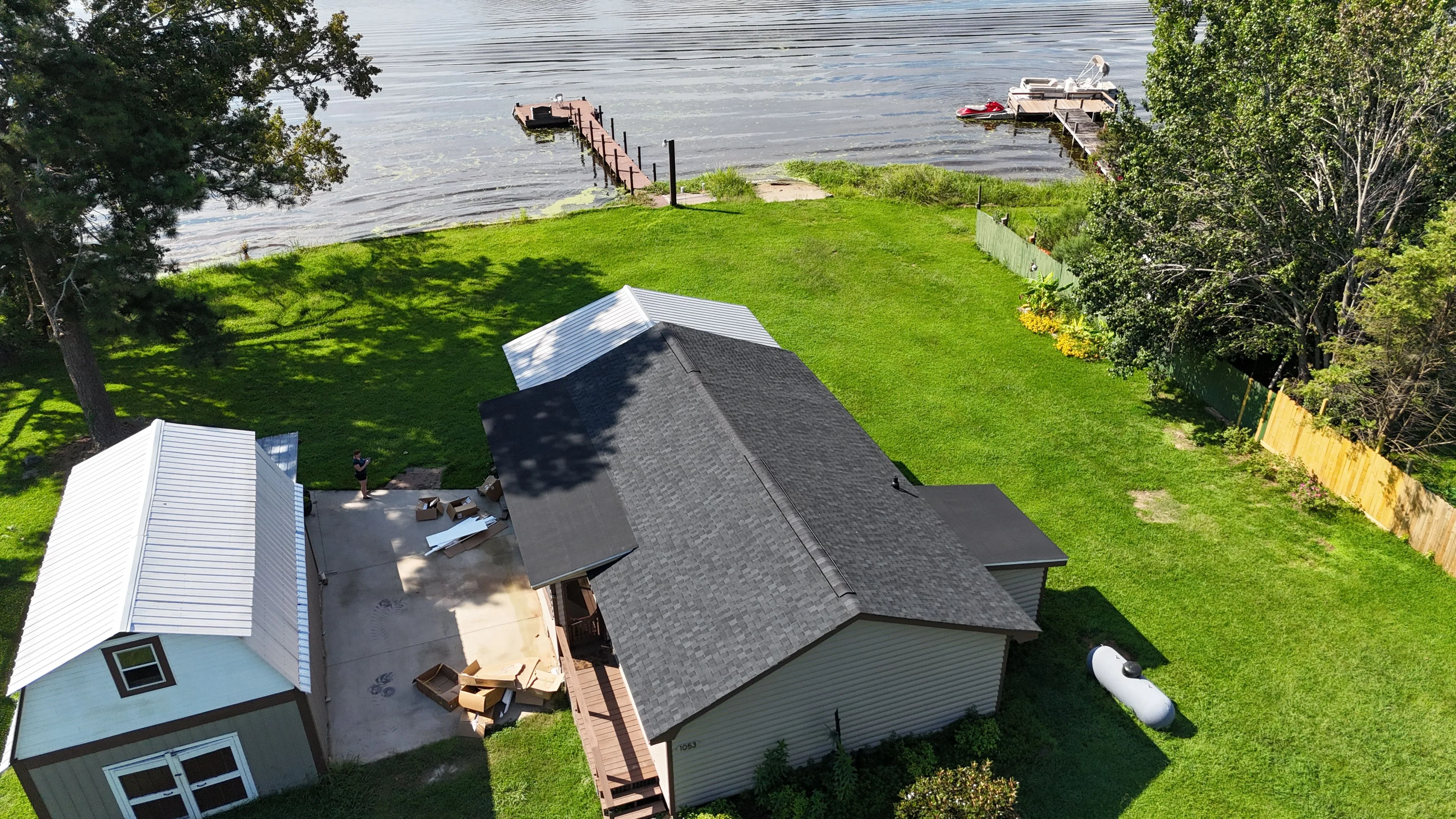 A completed roof replacement on a brick ranch home in Cayce, SC, showing new shingles installed from ridge to eave with clean flashing along the roofline. The surrounding yard and mature trees reflect the established residential character common to Cayce neighborhoods.